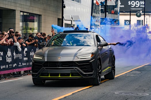 A Lamborghini Urus drives in a parade with a smoke bomb, captivating the crowd.
