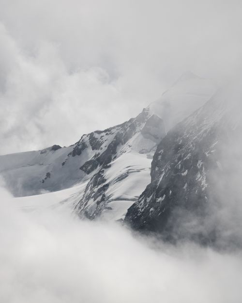 Free Dramatic view of misty mountain peaks in Tirol, Austria, showcasing winter's raw beauty. Stock Photo