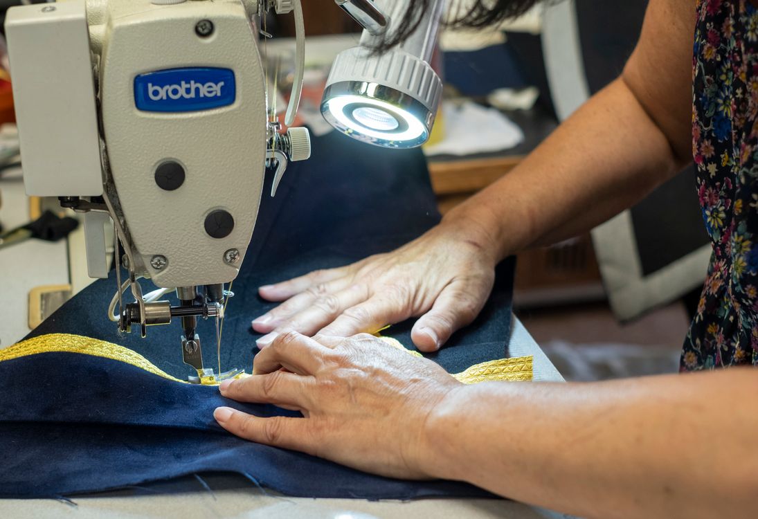 A Person Using a Sewing Machine · Free Stock Photo