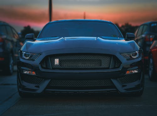 Close-Up Shot of a Black Luxury Car in the Parking Lot