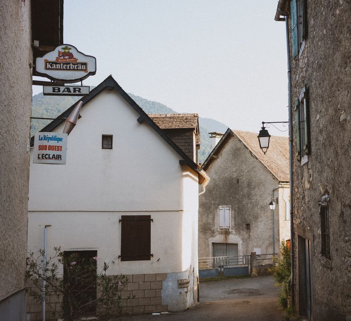 Sunlit alley with traditional architecture in a European village, evoking travel nostalgia.