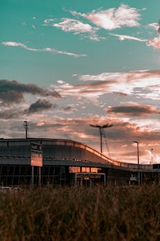 Stunning view of an airport terminal with a dramatic sunset sky in the background.