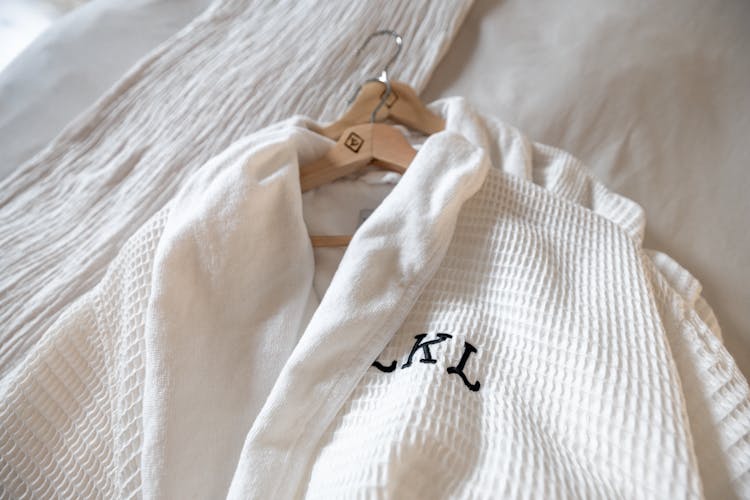 White Robe With Black Initials On A Hanger