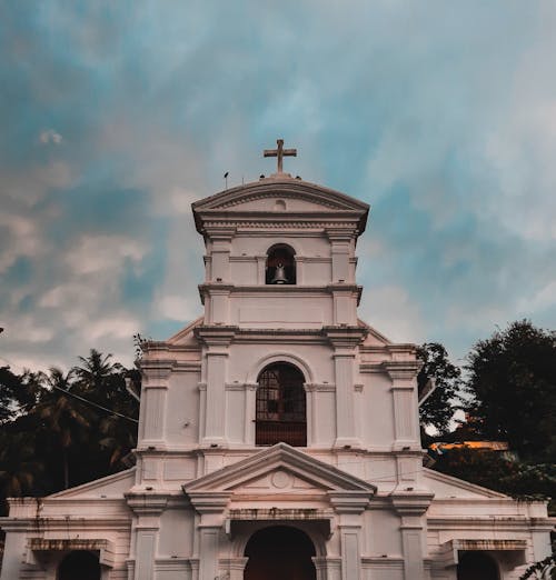 Photo of White Church Under Cloudy Sky