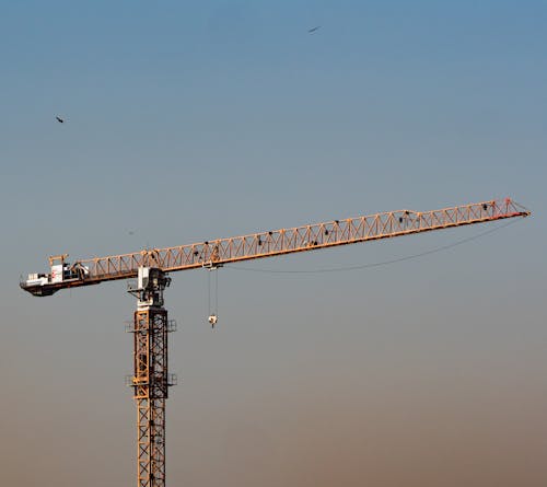 Brown Metal Crane Under Blue Sky