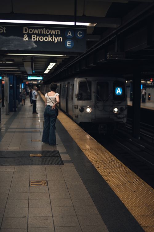 Free A person waits for the subway train arriving at a downtown Brooklyn station. Stock Photo