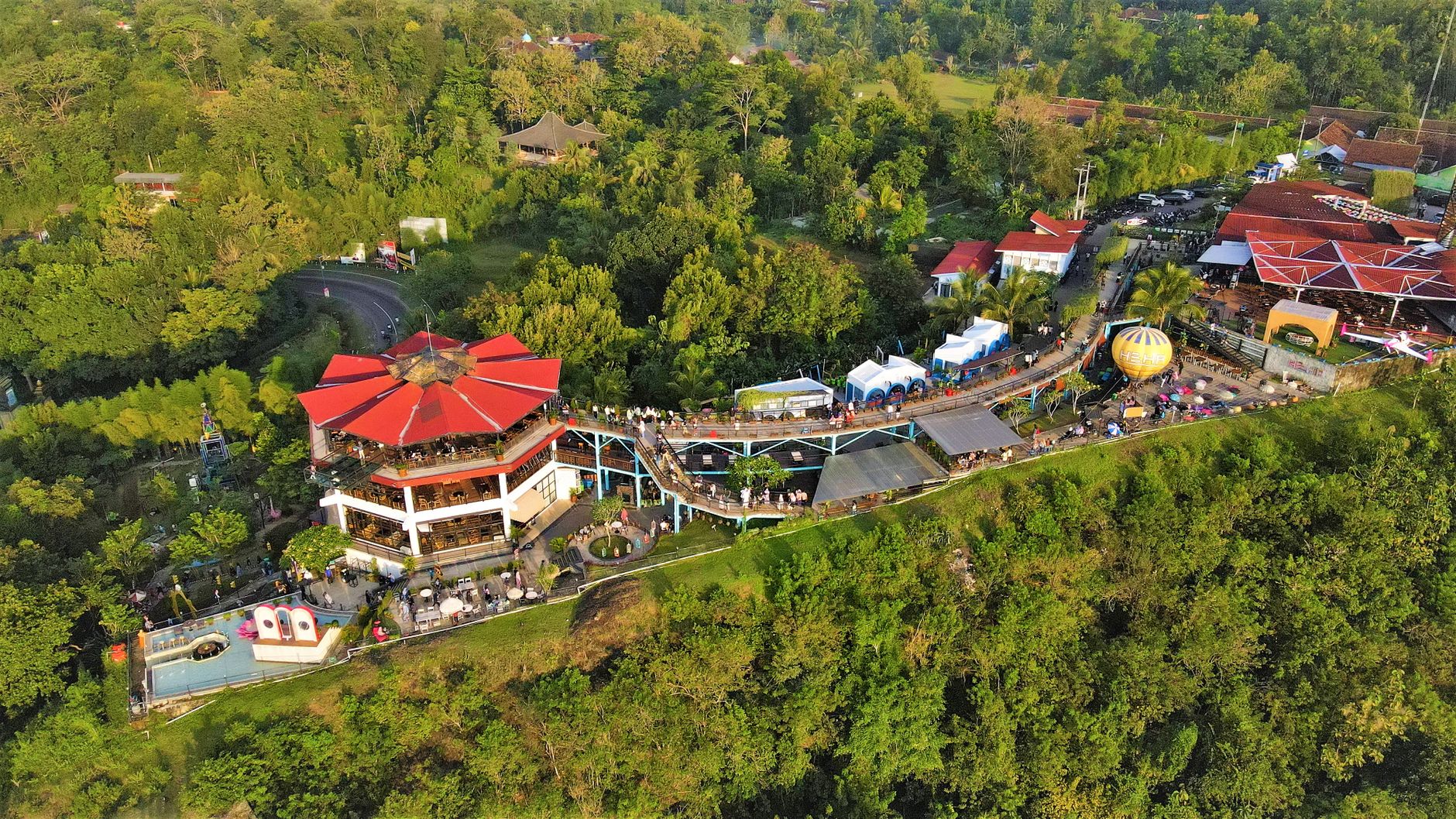 Vibrant aerial photo of a popular attraction in Yogyakarta, featuring lush greenery and unique architecture.