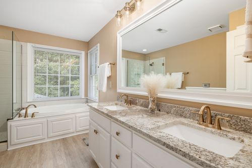 Free Bright and spacious bathroom featuring granite countertops and stylish fixtures. Stock Photo