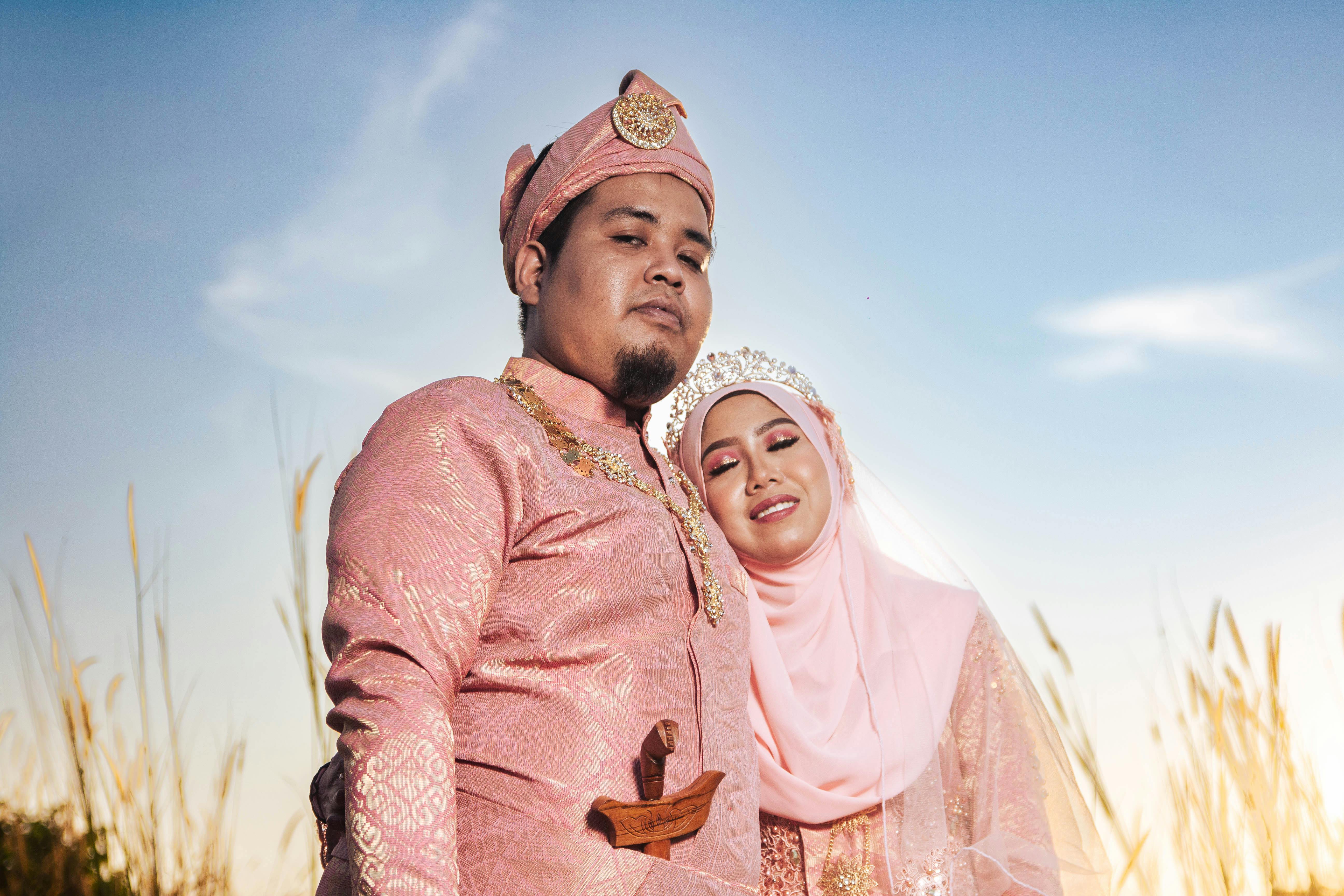 portrait of newlyweds in pink traditional clothing