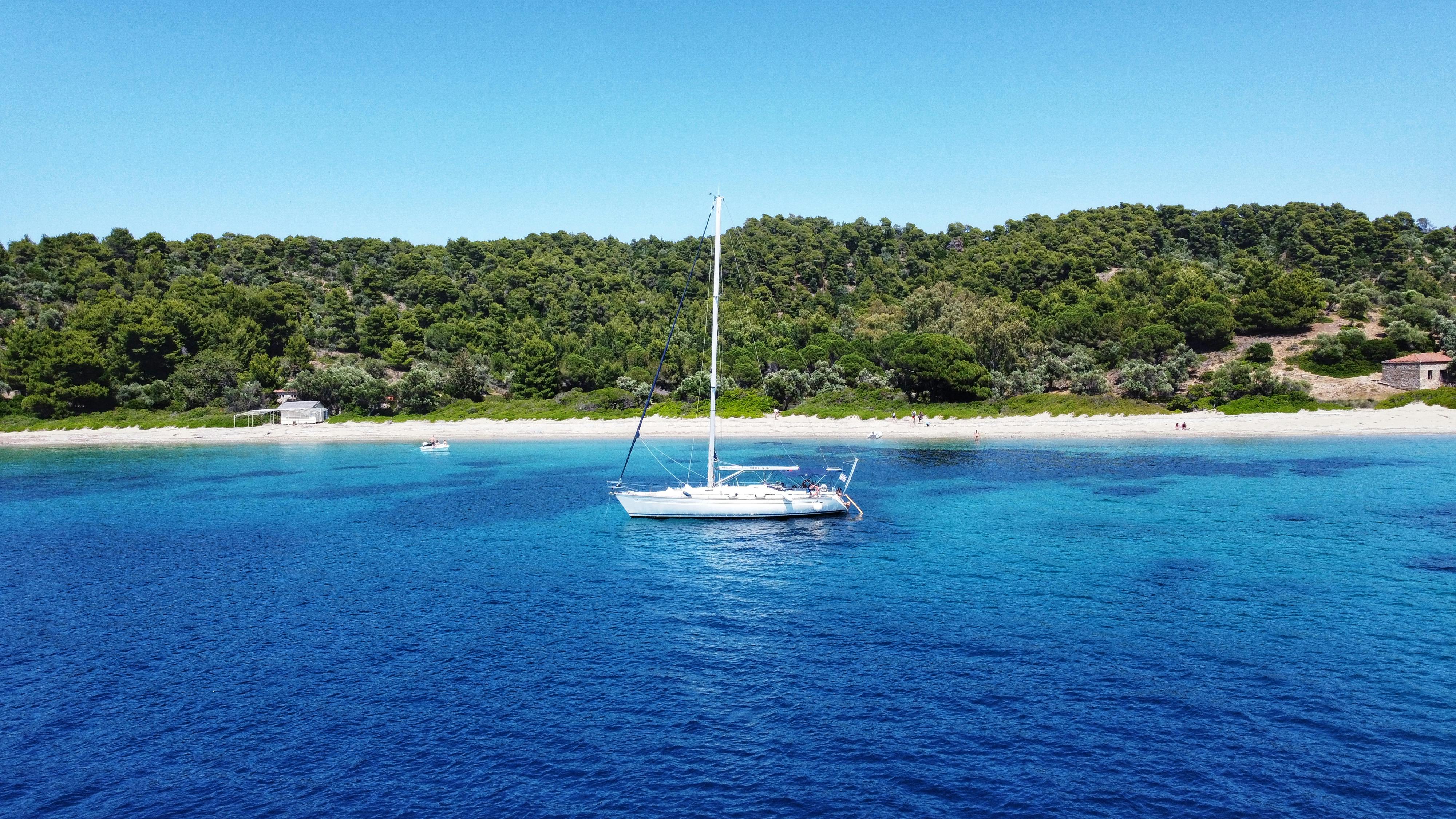 Private yacht charters. Free Sailing Boat near Tsougrias beach island, Skiathos Greece Stock Photo