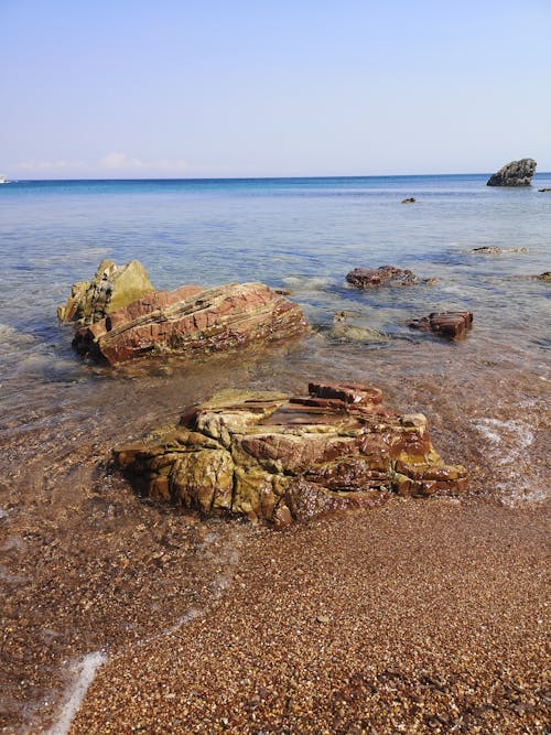 Free Brown Rock Formation on Sea Shore Stock Photo