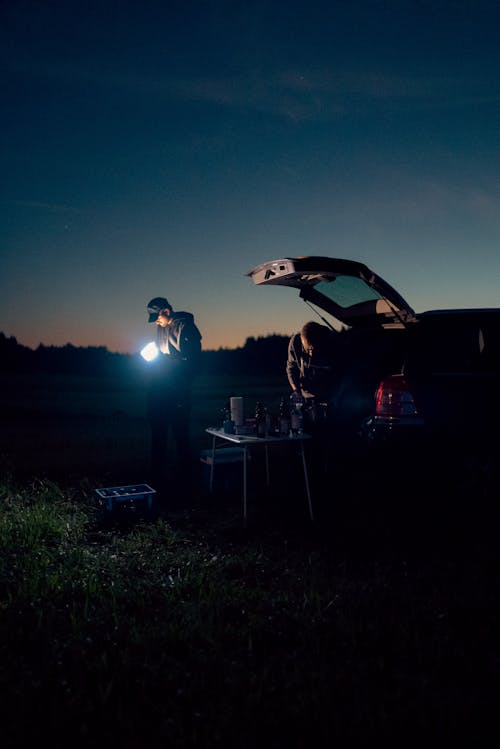 Free camping dinner at night from the car boot Stock Photo