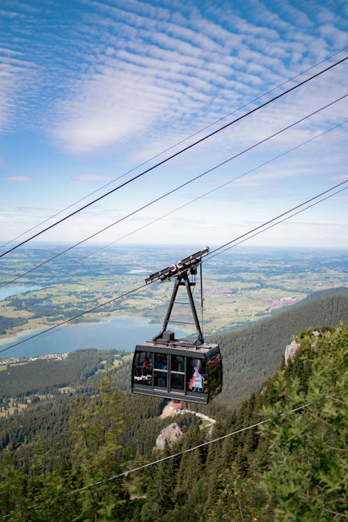 Free cable car on its way up the mountain Stock Photo