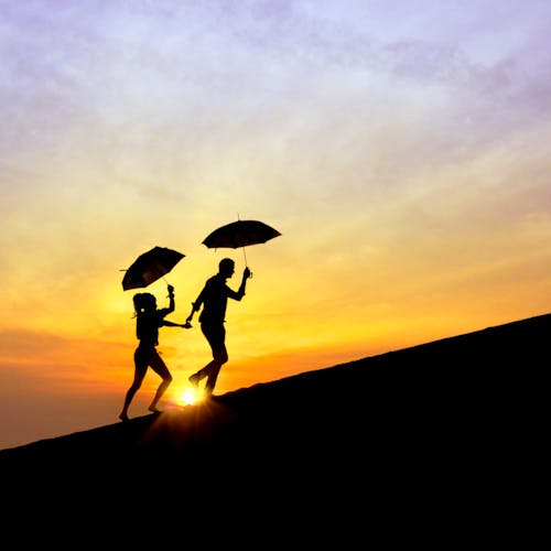 Free Silhouette of Person Holding Umbrella during Sunset Stock Photo