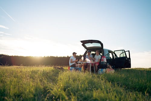 camping picnic from the car boot with a sunset and snacks