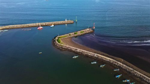 Free Aerial shot of Pangandaran coastline in Indonesia, showcasing piers and vivid blue waters, ideal for travel imagery. Stock Photo