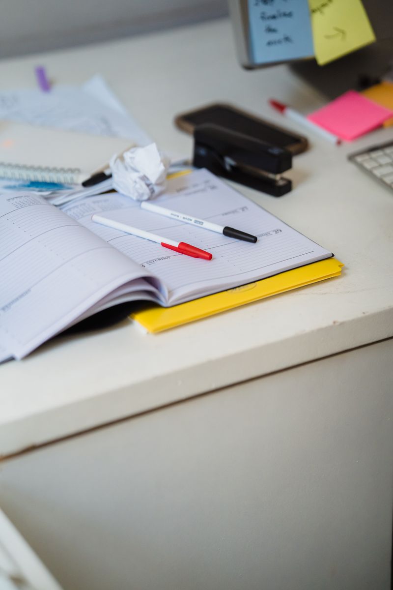 Weekly planner and pens on a desk, batching a week of content in one sitting