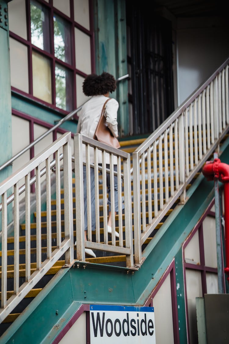 Woman Walking Up Steps At A Subway Station