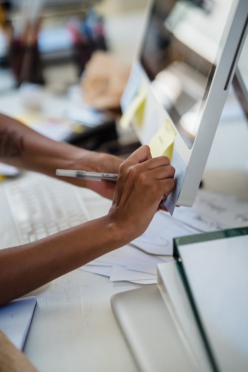 Free Hand Writing on a Sticky Note on a Computer Monitor Stock Photo