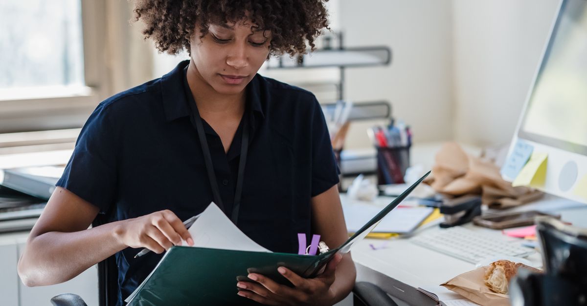 Reading.doc Businesswoman Reading Documents in an Office · Free Stock Photo