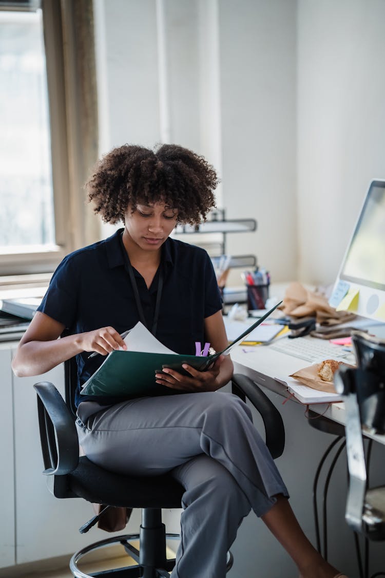 Businesswoman Reading Documents In An Office