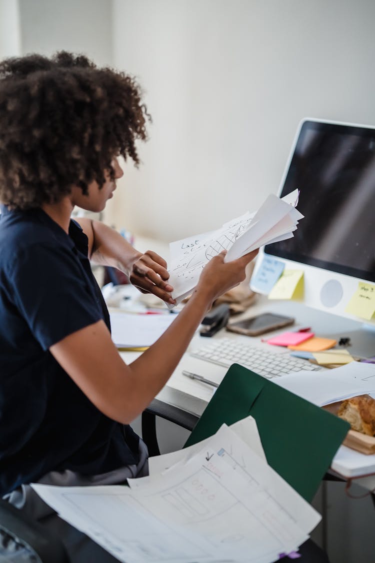 Female Office Worker Looking At Documents