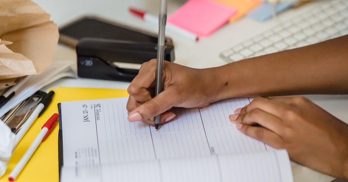 File With Writing Woman Writing on Documents in Office · Free Stock Photo