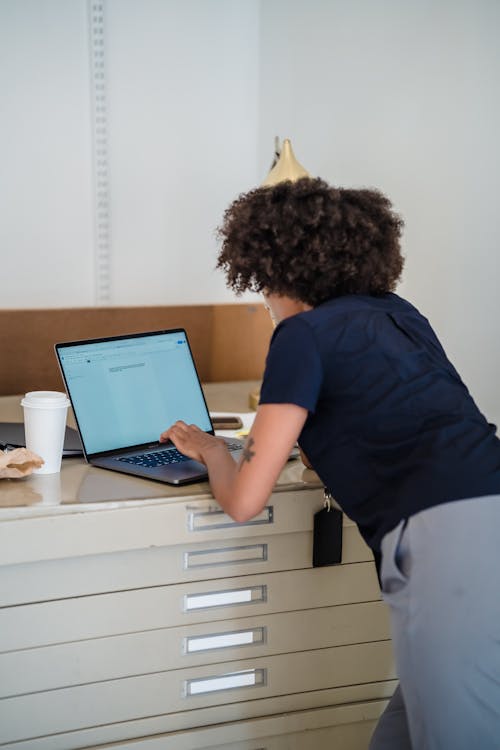 Woman Using a Laptop in an Office