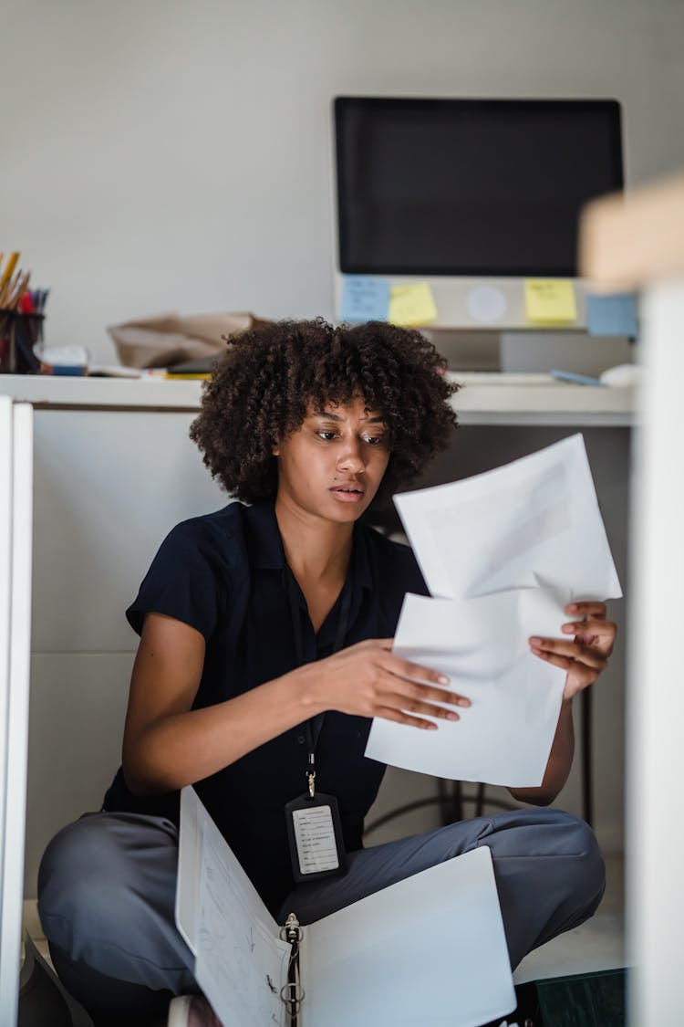 Woman Looking At Documents In An Office