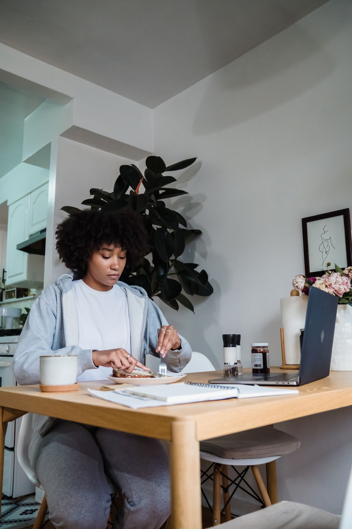 Person budgeting for everyday household expenses at a table