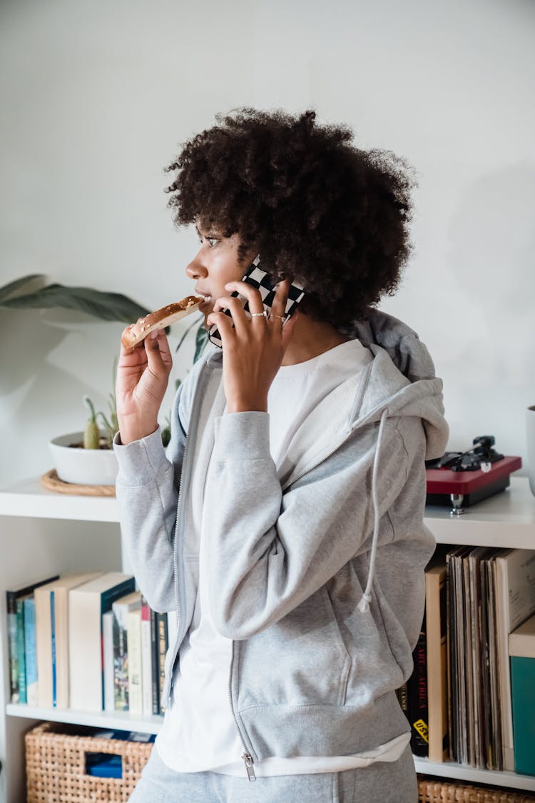 Woman Eating Toast Talking On Phone