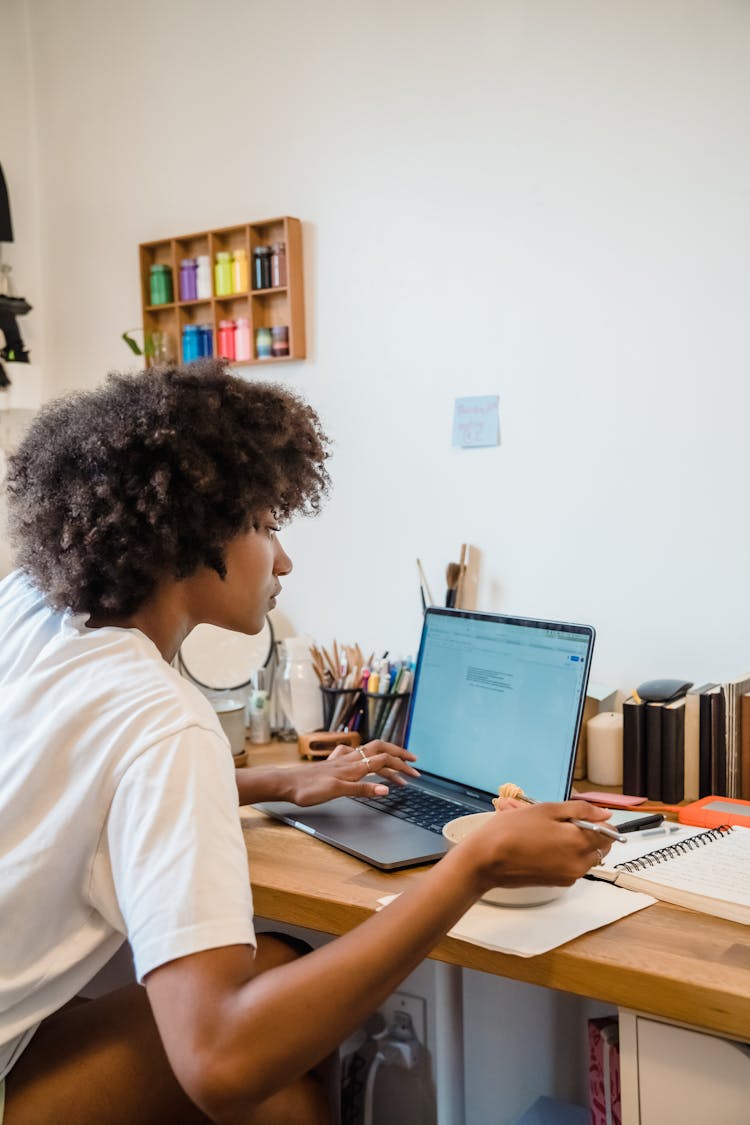 Woman Working On Laptop And Eating Lunch 