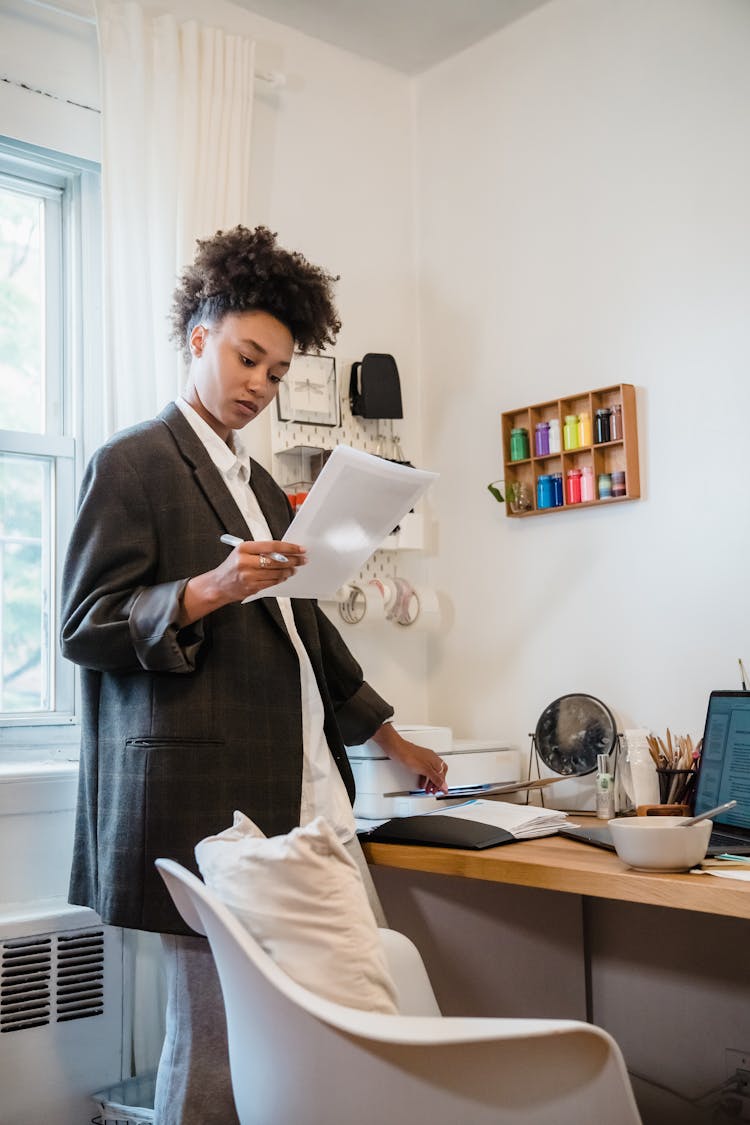 Woman While Printing Business Documents At Home