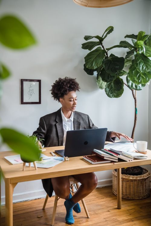 Woman working from home on a laptop representing earning through done-for-you affiliate marketing