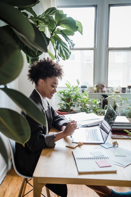 Smiling Woman Sitting at Desk in Office