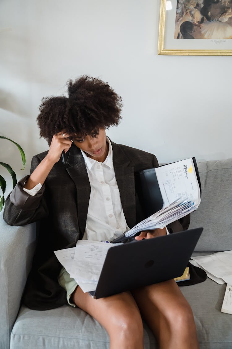 Tired Woman Working With Documents And Laptop From Home