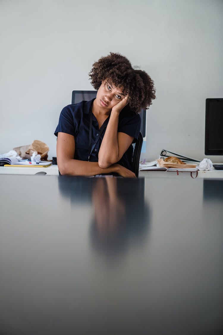 Woman Looking Bored And Tired Sitting In An Office 