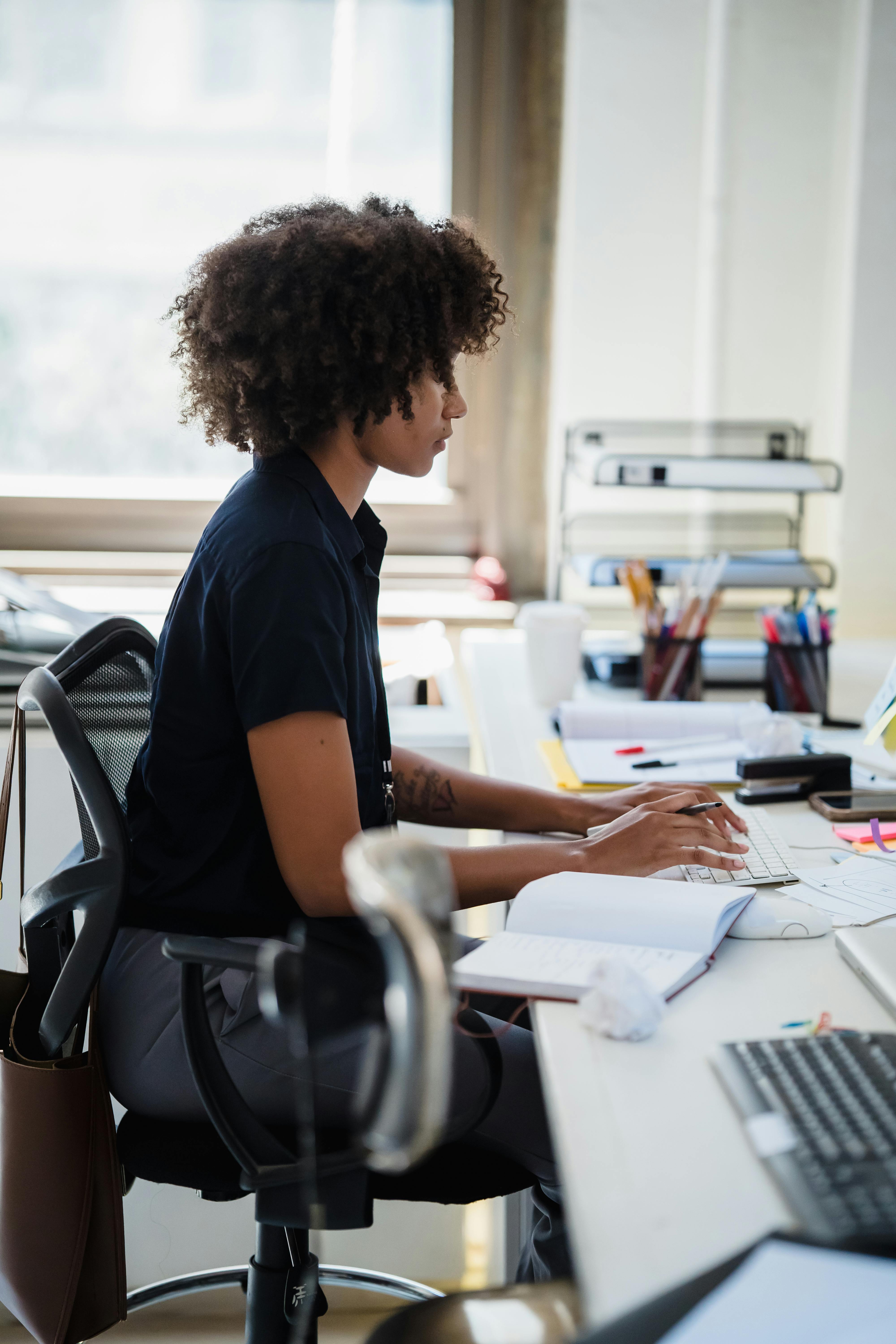 Female Office Worker Looking at Documents · Free Stock Photo
