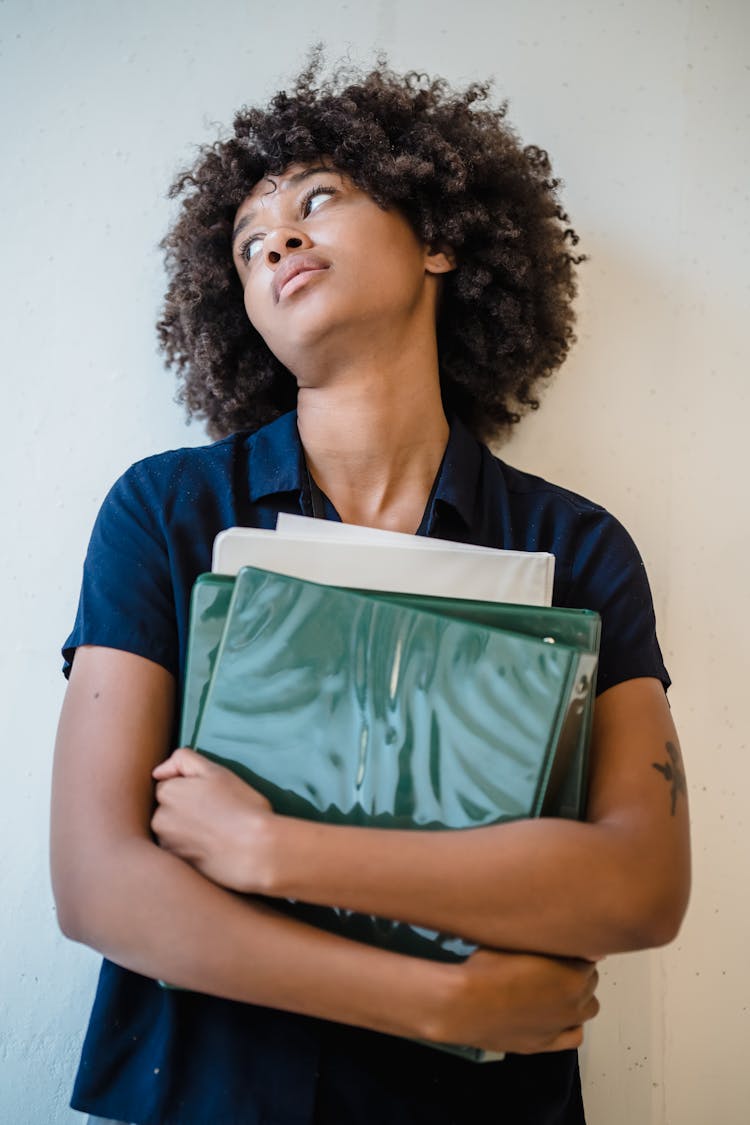 Tired Woman Holding Stack Of Papers