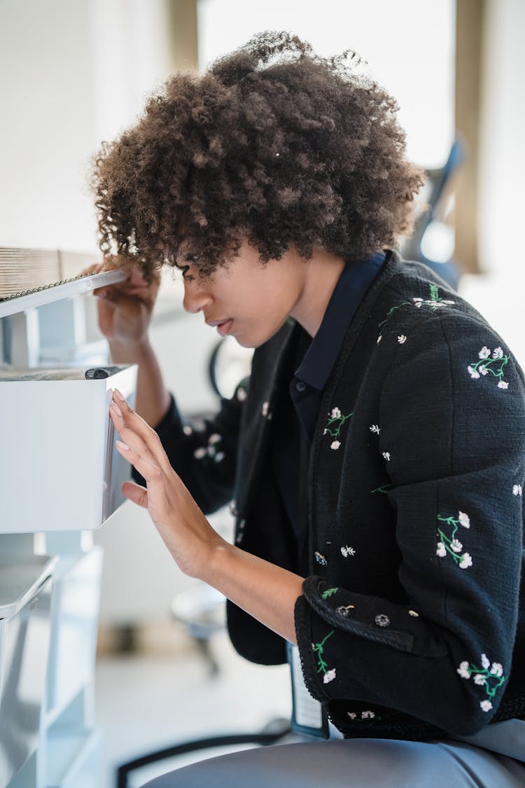 Woman Peeking The Inside Of A Box In An Office