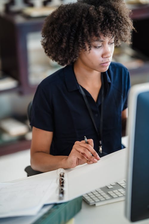 Free Woman in Black Polo Shirt Using White Tablet Computer Stock Photo