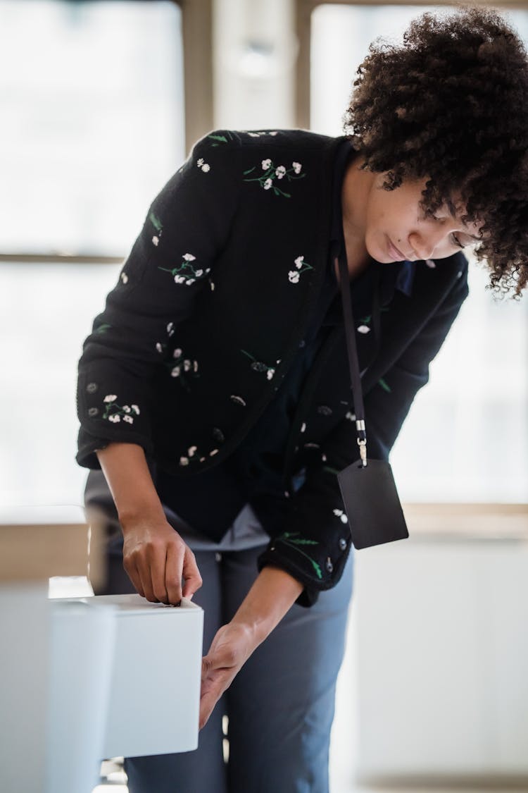 Woman Pulling Out A Drawer 