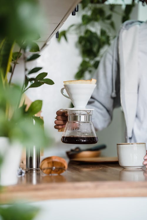 Close-up of a Woman Brewing Coffee in a Pot