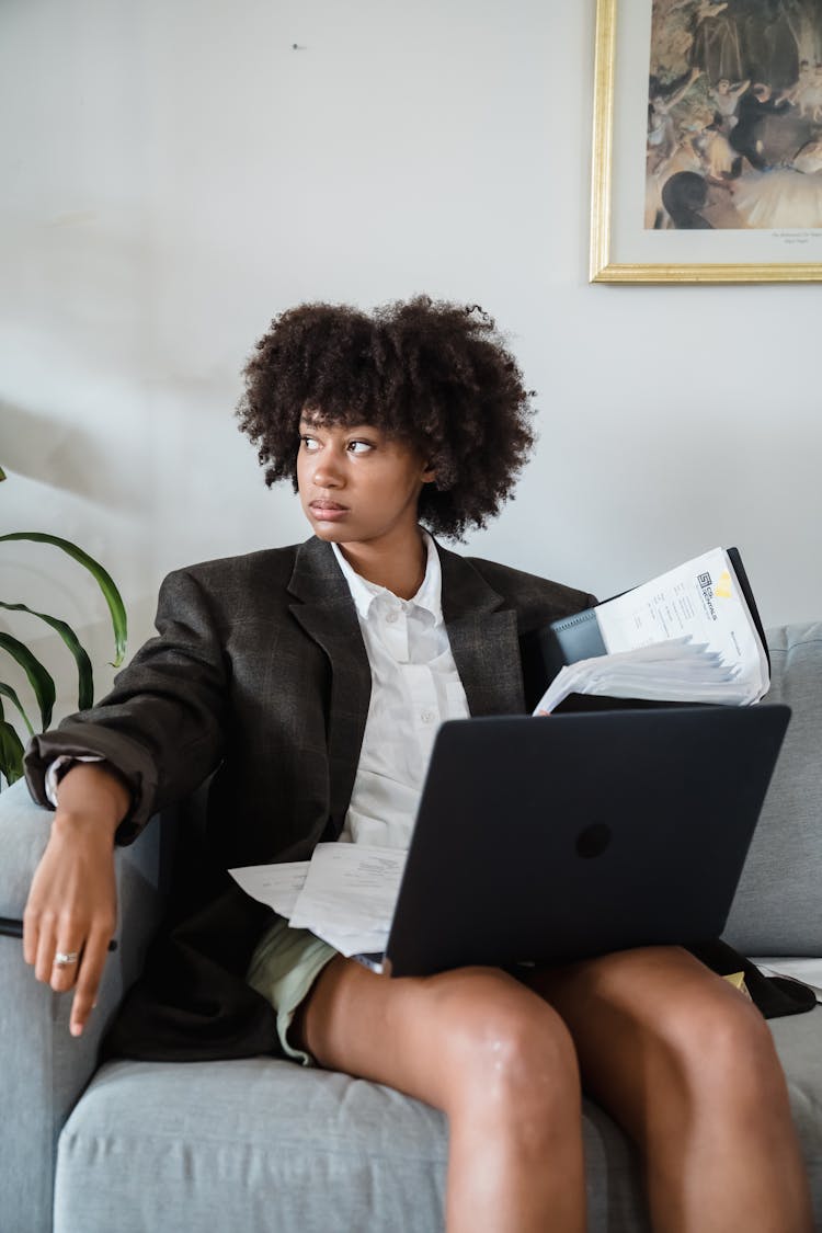 Woman Sitting On Couch Working