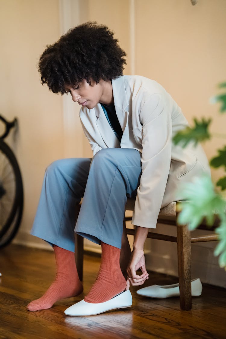 Woman Putting On Shoes