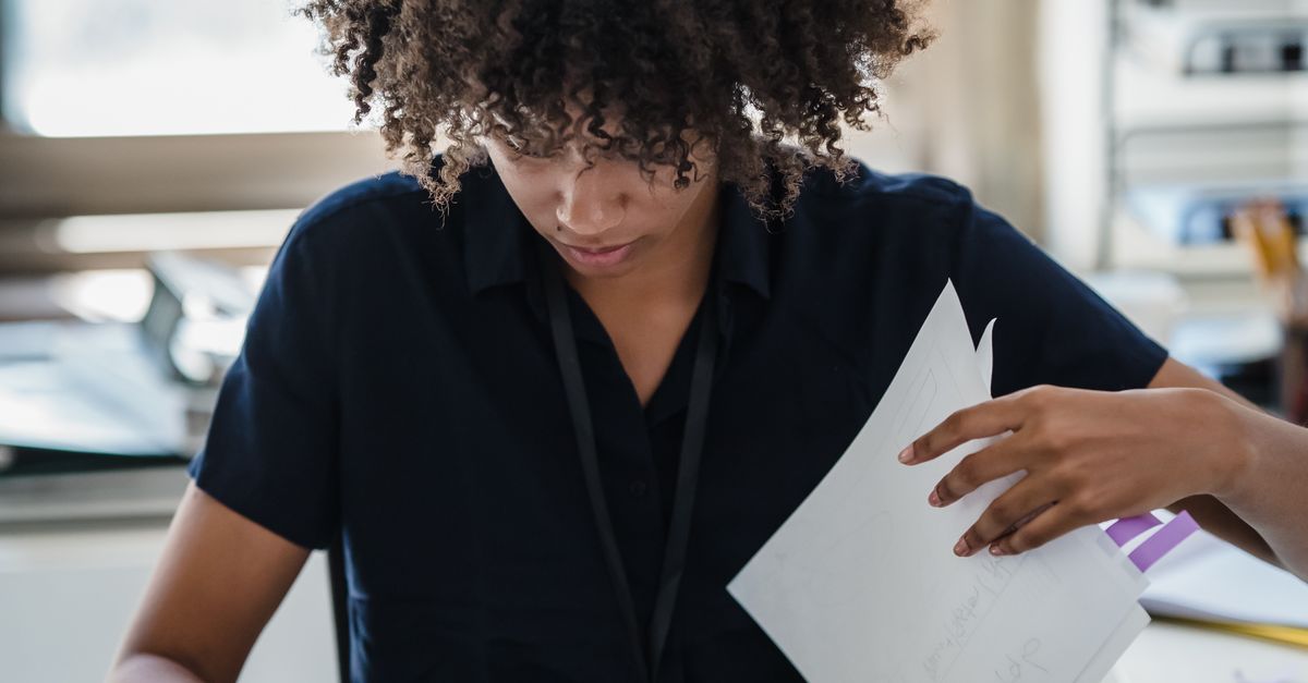 Reading.doc Woman Reading Documents in Office · Free Stock Photo