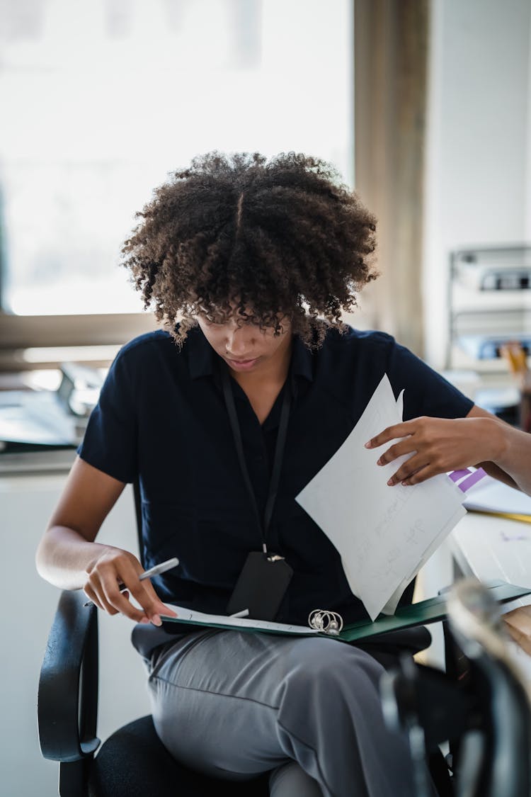 Woman Reading Documents In Office