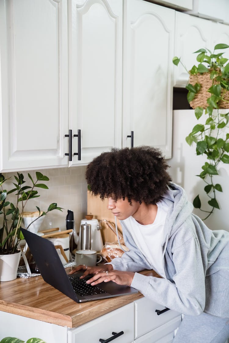 Woman Working On Kitchen Counter