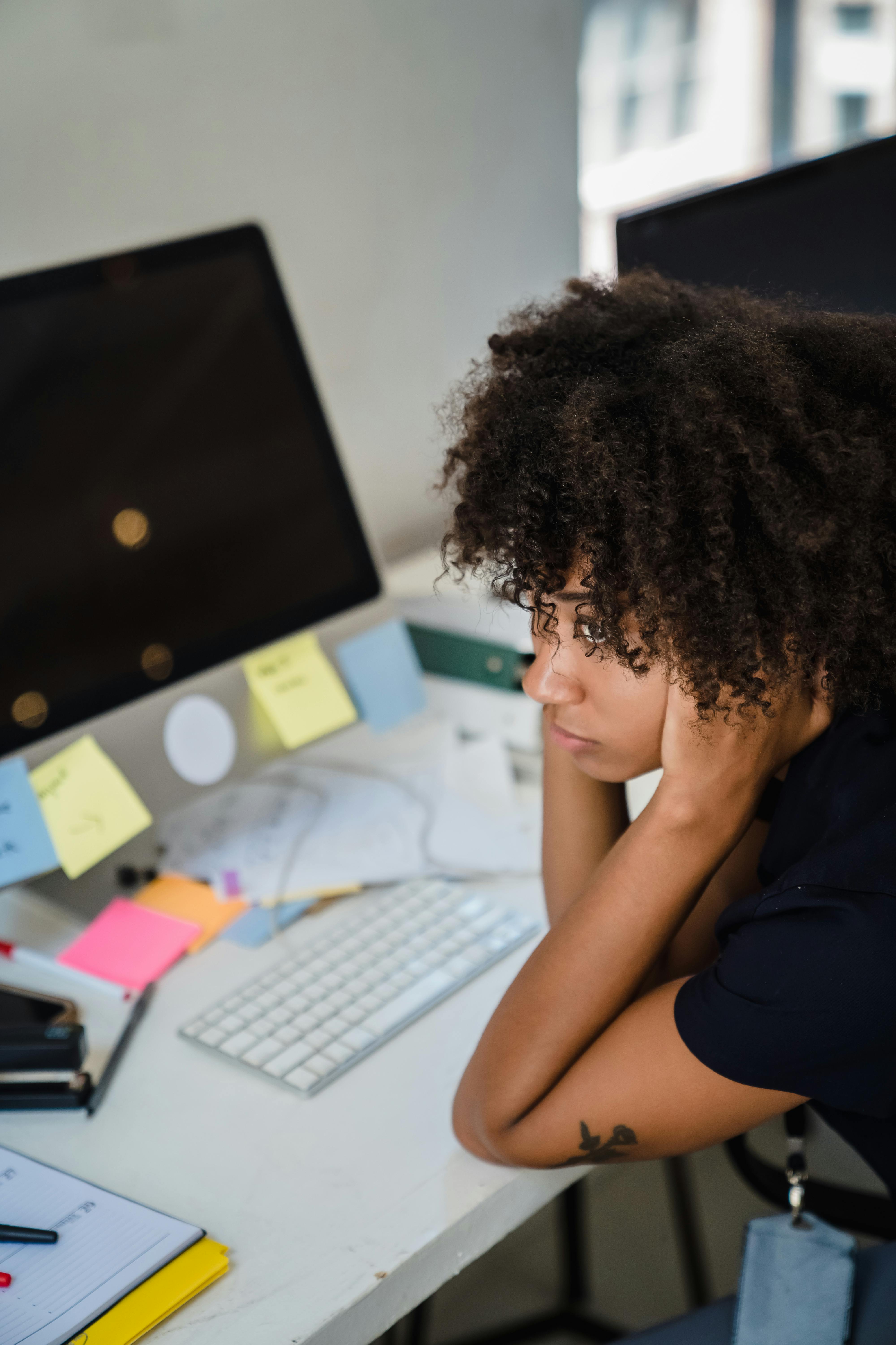 Tired Woman Sitting by Desk at Home