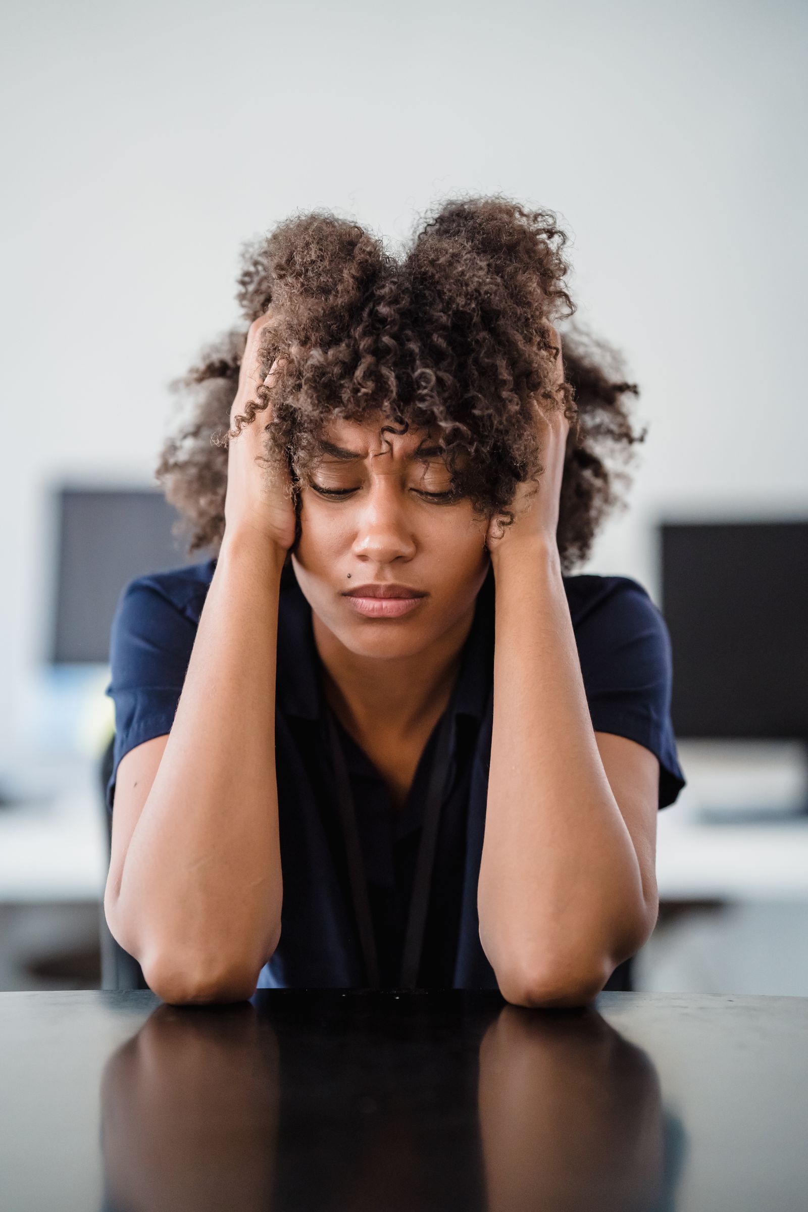 Tired woman resting with her hands in her hair